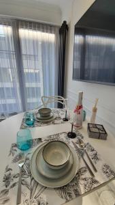 a table with plates and utensils on top of it at Lividus 432 By Edyta in Świnoujście
