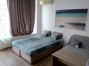 a bedroom with a bed and a couch and a window at Silver Beach A98 in Byala