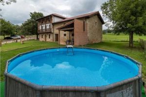 a large pool in front of a house at Espectacular villa rural en Cabárceno in Penagos