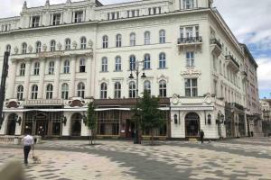 a large white building with people in front of it at Studio flat in the center of Budapest in Budapest