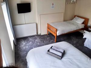 a bedroom with a bed and a television at Railway Bar Accommodation in Poyntz Pass