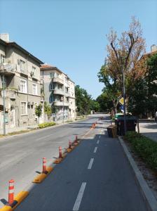 an empty street with orange traffic cones on it at Jazz & Wine - Luxury apARTment By The Sea & Parking & HBO & Netflix in Varna City