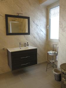 a bathroom with a sink and a mirror on the wall at Casa Nonna Stella in Martina Franca