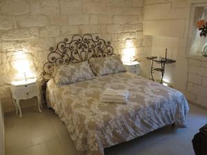 a bedroom with a bed with two towels on it at Casa Nonna Stella in Martina Franca