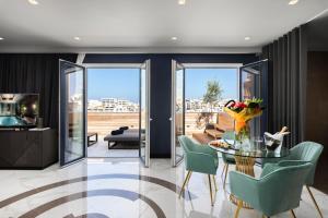 a dining room with a glass table and chairs at Lure Hotel & Spa - Adults Only in Mellieħa