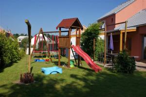 a playground with a slide in a yard at Buxusson Resort in Lomnice nad Lužnicí