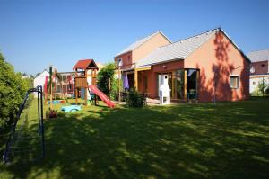 a yard with a playground and a house at Buxusson Resort in Lomnice nad Lužnicí