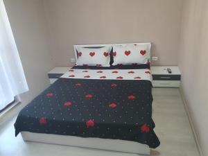 a bedroom with a bed with hearts on it at Casa Simionov in Băile Herculane