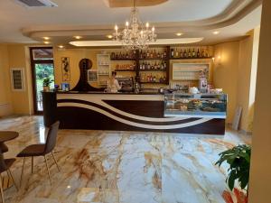 a bar in a restaurant with a marble floor at Hotel Ristorante Villa Terry in Lauria Inferiore