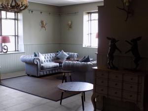 a living room with a couch and a table at Flynns of Termonfeckin Boutique Hotel in Termonfeckin