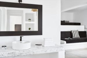 a bathroom with a sink and a mirror at Mr & Mrs White Mykonos in Platis Gialos