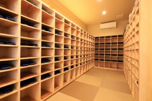 a walk in closet with lots of shelves at 白浜の宿　 蘭 in Shirahama