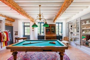 a pool table in the middle of a room at La Petite Aiguebonne in Allex