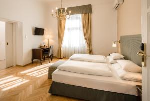 سرير أو أسرّة في غرفة في Palais-Hotel Erzherzog Johann