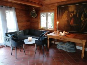 a living room with a couch and a table at Brīvdienu māja Mākoņi in Ratnieki