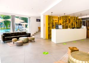 a living room with yellow cabinets and a couch at ibis Styles Golden Sands Roomer Hotel in Golden Sands