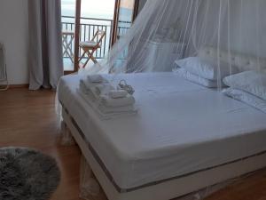 a white bed with a tray of towels on it at Room Domo in Senj