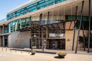 a large glass building with a staircase in front of it at Arrecife Gran Hotel & Spa in Arrecife
