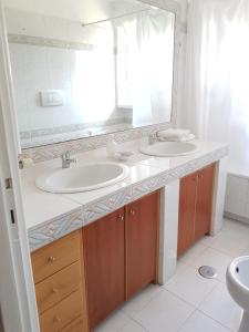 a bathroom with two sinks and a large mirror at Casa di Monica e Mauro in Rome +30 photos