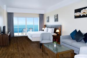 A bed or beds in a room at Ramada by Wyndham Beach Hotel Ajman