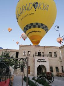 a yellow hot air balloon in front of a building at Cappadocia Fairy Tale Suites in Goreme