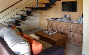 a living room with a couch and a staircase at Apartamentos Rurales El Calama in Zarza de Granadilla