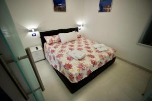 A bed or beds in a room at Ambra Apartment