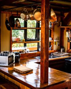 a kitchen with a wooden counter top with a microwave at Shamba lodge in Arusha