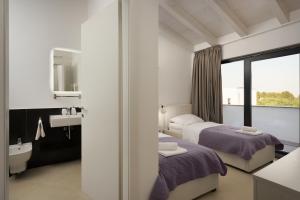 a hotel room with two beds and a sink at Sea View Villa Cala Royal in Krnica +32 photos