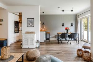 a living room with a kitchen and a dining room at 54' Nord Damp in Damp