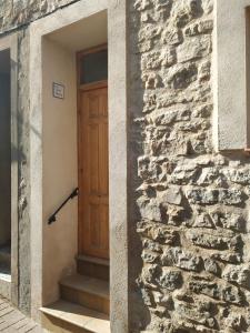 a wooden door on the side of a stone building at Casa Vall Bona in Pobla de Masaluca