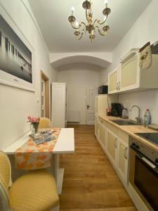 a kitchen with a table and a chandelier at Apartmány u sv. Michaela in Kadaň