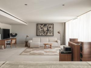 a living room with a couch and a table at OKU Ibiza in San Antonio