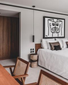 a bedroom with a bed and a chair at OKU Ibiza in San Antonio