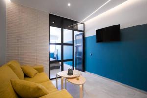 a living room with a yellow couch and a table at City Center Modern Renovated Apartment in Athens