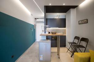 a kitchen with a counter and chairs in a room at City Center Modern Renovated Apartment in Athens