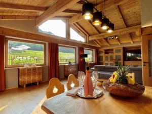 a living room with a table and a couch at Kitzbühel Beach Chalet " Ski-in & Ski-out " in Kitzbühel