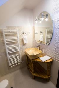 a bathroom with a sink and a mirror at Royal Inn Busteni-Adults Only in Buşteni