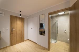 a room with a sliding glass door and a television at Villa Aura in Świnoujście