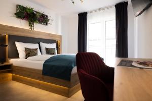 1 dormitorio con cama, silla y escritorio en Bed and Breakfast - Homburg am Main, en Homburg