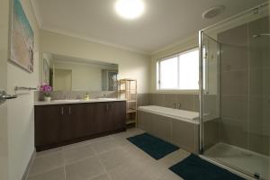 a bathroom with a tub and a sink and a shower at 6 Bedrooms & 4 Bathrooms Big House for Big Group in Point Cook +58 photos