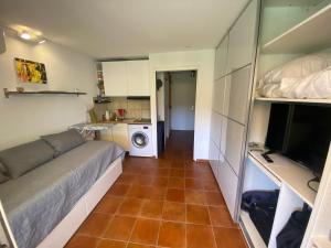 a small apartment with a couch and a kitchen at Boost Your Immo Six Fours Les Plages Jardins Azur 511 in Six-Fours-les-Plages
