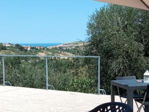 a table and chairs on a patio with a view at b&b L'Alloggio in Fermo