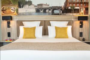 a bed with white pillows and a view of a bridge at Residhome Toulouse Ponts Jumeaux in Toulouse