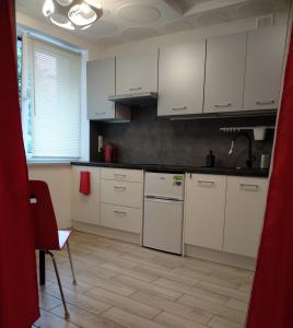 a kitchen with white cabinets and white appliances at Niedaleko od Centrum ale Z dala od tłumów in Lublin