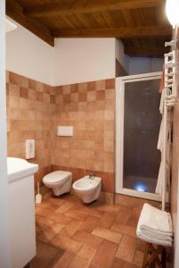 a bathroom with a toilet and a bidet at Agriturismo La Zangola in Tremosine Sul Garda
