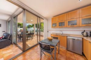 a kitchen and living room with a table and chairs at Finca Coll in Alcudia