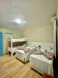 a room with two beds in a room at Pousada Quedas D'água in Foz do Iguaçu +54 photos