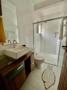 a bathroom with a sink and a toilet and a shower at Pousada Quedas D'água in Foz do Iguaçu