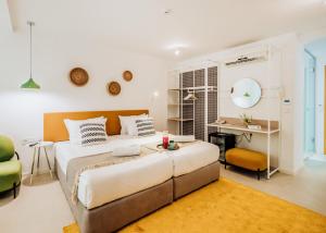 a bedroom with a large bed and a desk at ibis Styles Golden Sands Roomer Hotel in Golden Sands